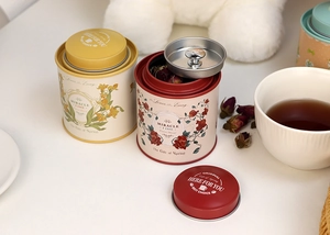 Detail of round tin canisters for tea or candy with vintage floral patterns on metal