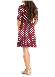 Back view of burgundy polka dot maternity dress showing elegant cut and drape detail