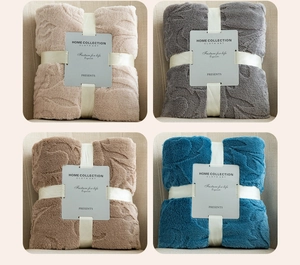 Detailed close-up showing embossed patterns and soft texture of thick flannel blankets
