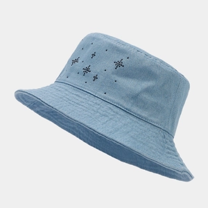 Detail of light blue denim bucket hat with black star-shaped rhinestone embellishments