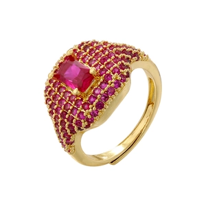 Macro view of adjustable gold ring featuring a rectangular red stone and pink crystals