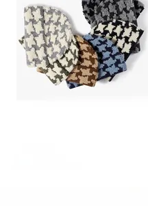 Detail of premium houndstooth jacquard knitting texture on various warm winter beanies