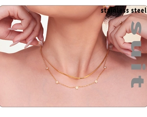 Double-layer gold stainless steel necklace with flat snake chain and star pendant on model