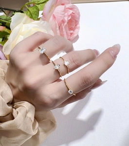 Detail shot of four gold-plated S925 silver rings with various moissanite stone cuts