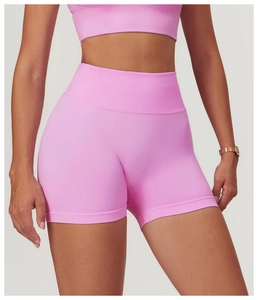 Detail of seamless high-waist yoga shorts in pink with ribbed waistband and texture