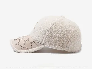 Close-up side view of the beige lamb wool baseball cap with rhinestone brim detailing