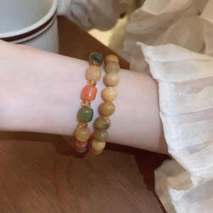 Handmade Bodhi seed beaded bracelets with cute puppy charm on model's wrist