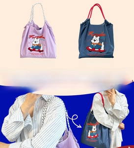 Close-up of West Highland Terrier embroidery and Freedom lettering on nylon tote bags