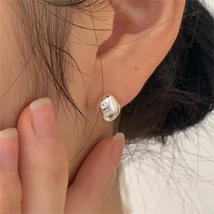 Irregular textured 925 sterling silver stud earring with zircon on model's ear