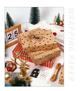 Close-up of Christmas kraft wrapping paper with gold stamping and red dot patterns