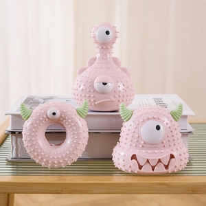 Detailed view of pink monster squeaky pet toys featuring unique textured silicone surface
