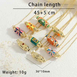 Detailed view of colorful enamel cylinder pendants with lucky engravings and zircons