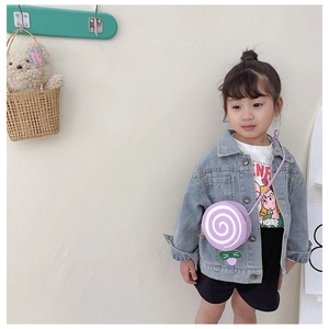 Toddler girl wearing a purple lollipop-shaped crossbody bag with a PU leather finish