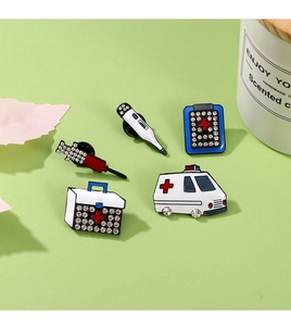 Detailed view of 5-piece medical enamel pin set with sparkling rhinestones on badges