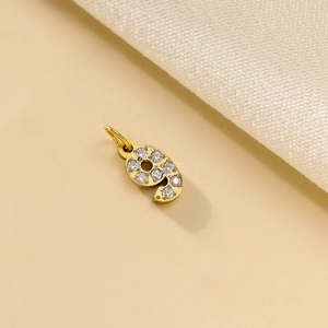 Detail of gold-plated number nine pendant with micro-pave cubic zirconia crystals