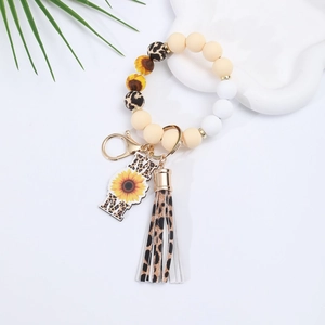 Detail of silicone bead keychain with leopard print, MOM sunflower charm and tassel