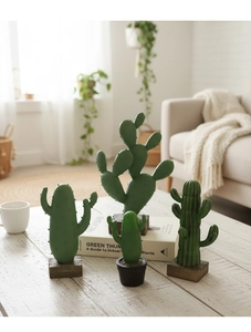 Detailed view of resin cactus ornaments with wooden bases on a modern coffee table