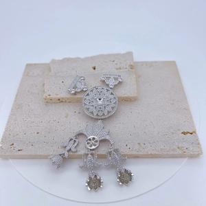 Detail of silver hollow sun flower pendant with sparkling zircon inlays on stone