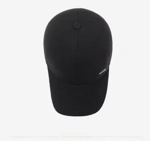 Top view of black winter baseball cap with thick wool texture and six-panel design