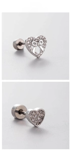 Macro detail of silver titanium steel heart earrings with bow design and zircon inlay