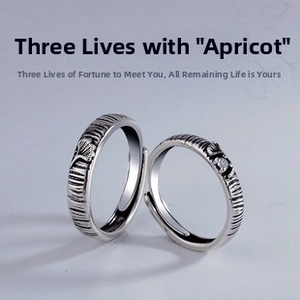 Close-up of adjustable silver ginkgo leaf rings with brushed texture and small zircon