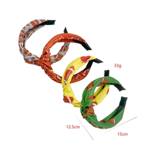Detailed view of four colorful football pattern headbands with size and weight labels