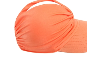 Detail view of the pleated orange fabric and extended brim on this sun visor hat