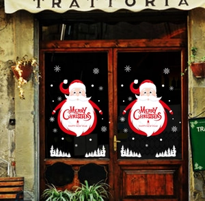 Detail of Santa Claus static window decals with Merry Christmas text on a glass door