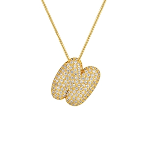 Macro shot of 18K gold plated necklace with zircon pavé letter W pendant on white background