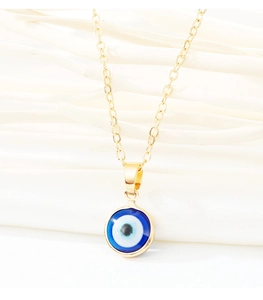 Close-up of golden stainless steel necklace featuring a blue evil eye resin pendant