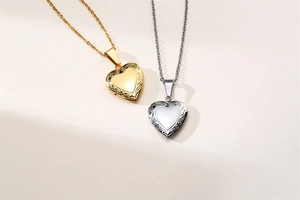 Detailed macro view of heart-shaped locket pendants with ornate embossed floral textures