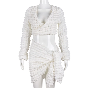 White two-piece popcorn texture set featuring a V-neck cropped top and tie-waist skirt