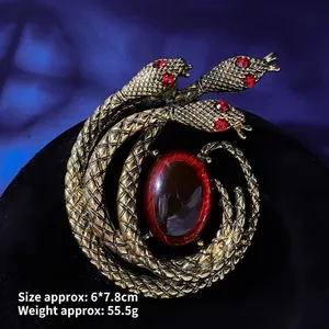 Macro shot of vintage three-headed snake brooch with red crystals and large gemstone