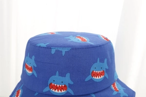 Detail of blue toddler sun hat with all-over shark pattern and durable cotton stitching