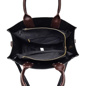 Top view of leather crossbody bag interior showing spacious compartments and zipper pockets
