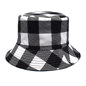 Detailed close-up of a black and white buffalo check bucket hat with canvas fabric texture