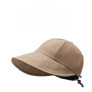 Detailed view of the adjustable windproof drawstring on this khaki sun hat