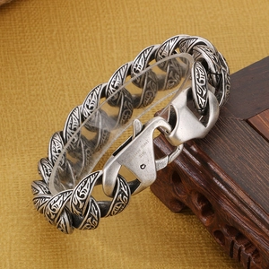 Detail of 316L stainless steel lobster clasp and engraved Cuban chain bracelet
