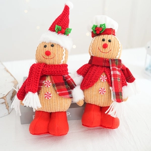 Close-up of knit gingerbread man dolls with red hats and scarves for Christmas decor