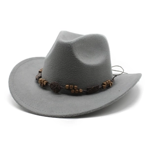 Detail of grey felt cowboy hat with vintage brown wooden bead band and circular ornament