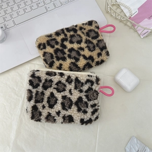 Flat lay of plush leopard print mini coin purses in brown and grey with pink drawstrings