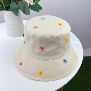 Close-up of colorful flower embroidery on a beige canvas sun hat for women