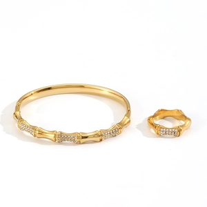 Bamboo-textured gold stainless steel jewelry set featuring a diamond-studded ring and bracelet