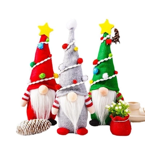 Three Christmas gnomes in red, gray, and green with white beards and star hats