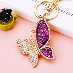 Macro view of crystal butterfly keychain with purple enamel and sparkling rhinestones