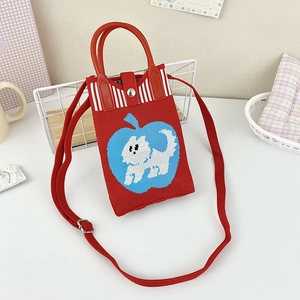 Close-up of red knitted tote bag with blue apple and puppy embroidery detail