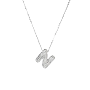 Detail of silver bubble letter N pendant with white cubic zirconia pavé on chain