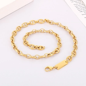 Detail of golden stainless steel pig nose anchor chain necklace with rectangular pendant