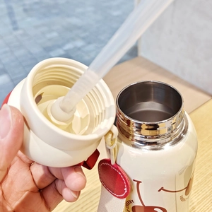 Detailed close-up of 316 stainless steel bottle rim and straw with cherry charm