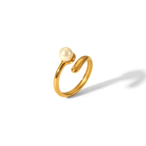 Close-up of golden adjustable stainless steel open ring with a round white pearl detail
